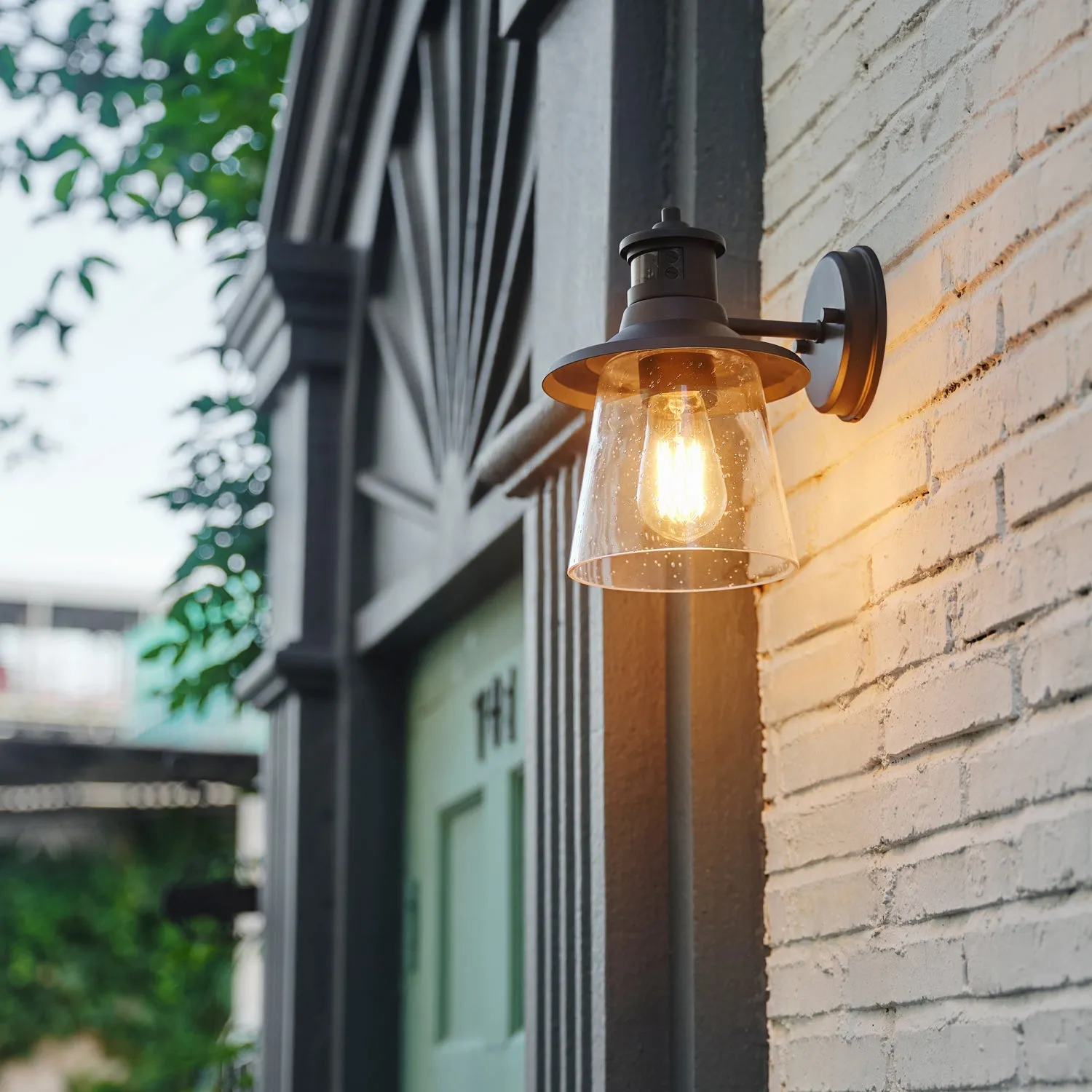 Juno 1-Light Matte Black Motion Sensor Outdoor Wall Sconce with Clear Seeded Glass Shade