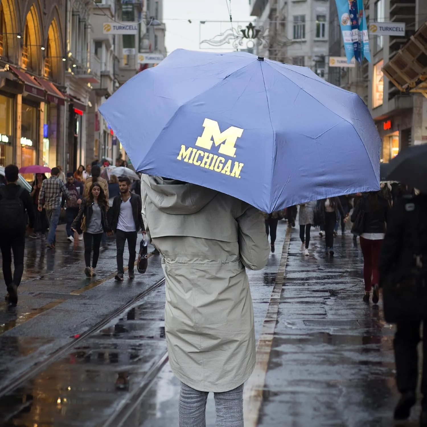 Mini Compact Storm Umbrella - NCAA Logo 42” Coverage, Folds to 11 Inches- Swivel Clip on Handle - Water, Wind & Rust Resistant, and Flexible Frame